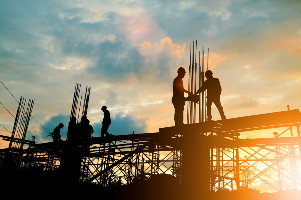 Silhouette of engineer and construction team working at site over blurred background sunset pastel for industry background with Light fair.Create from multiple reference images together.